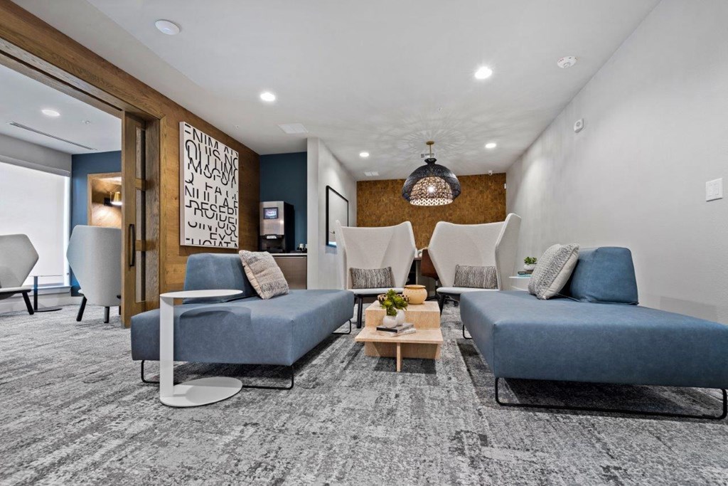 a living room with couches and chairs and a table