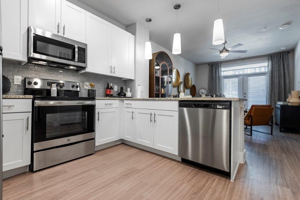a kitchen with stainless steel appliances and white cabinets