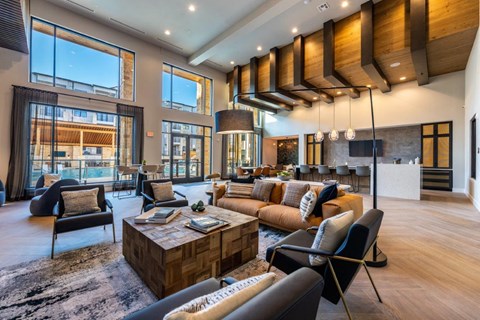 a large living room with couches and chairs and a table