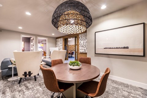 a dining room with a table and chairs and a large chandelier
