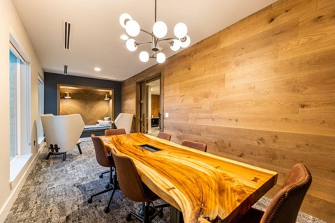 a conference room with a wooden table and chairs