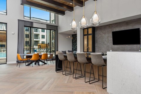 a bar and dining area in a room with large windows