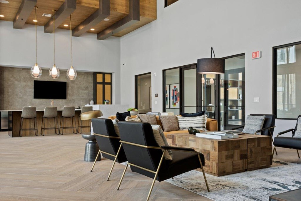 a living room with a couch and chairs and a table