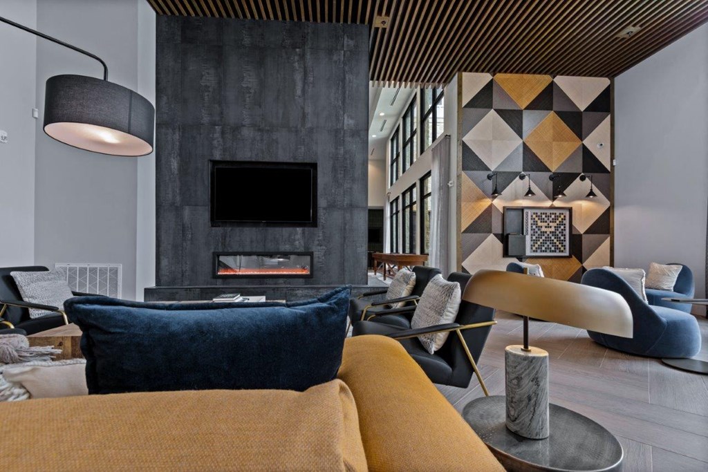 a living room with couches and chairs and a fireplace