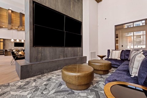 a living room with a blue couch and a large television