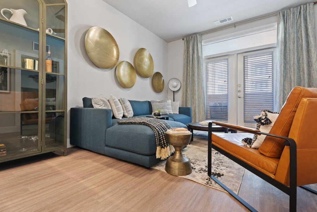 a living room with a couch and a table in front of a window