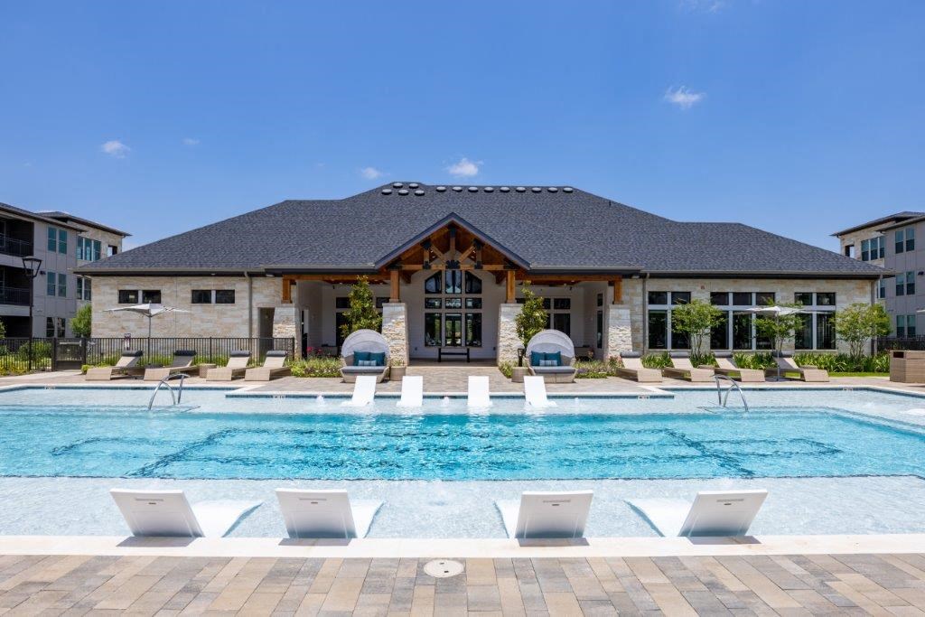 a house with a swimming pool in front of it
