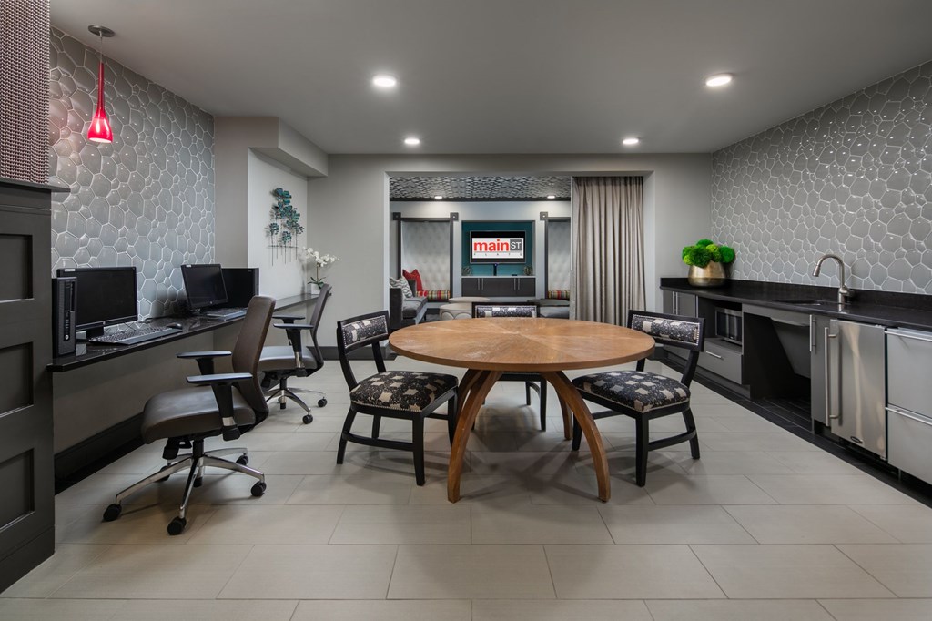 A modern kitchen with a dining table and chairs.