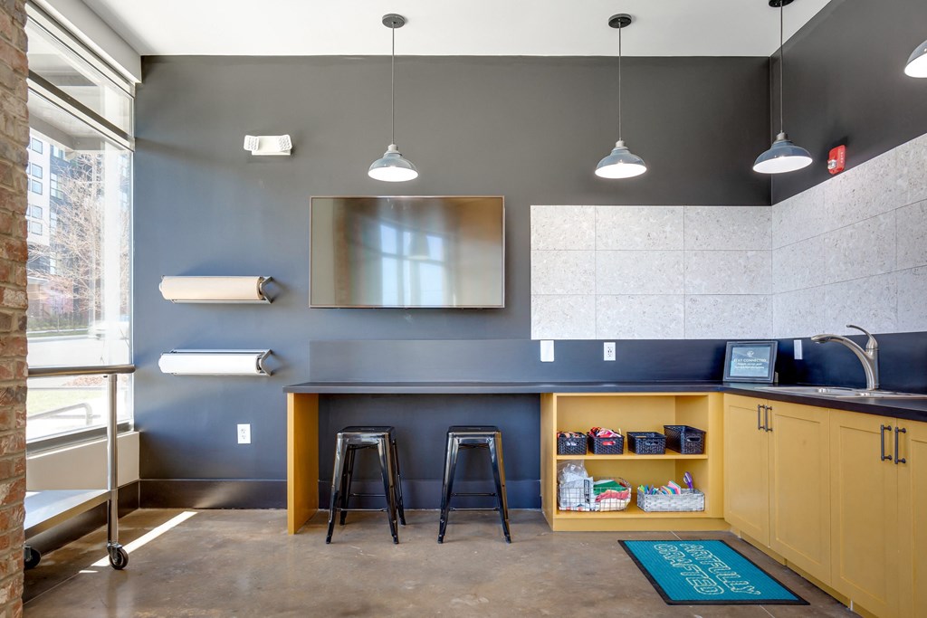 a kitchenette with a bar and stools