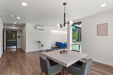 A modern dining room with a table and chairs.