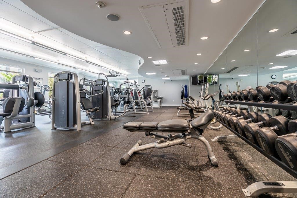 The Mercer Apartment Fitness Center free weights and bench