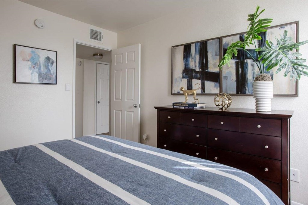 a bedroom with a bed and a dresser