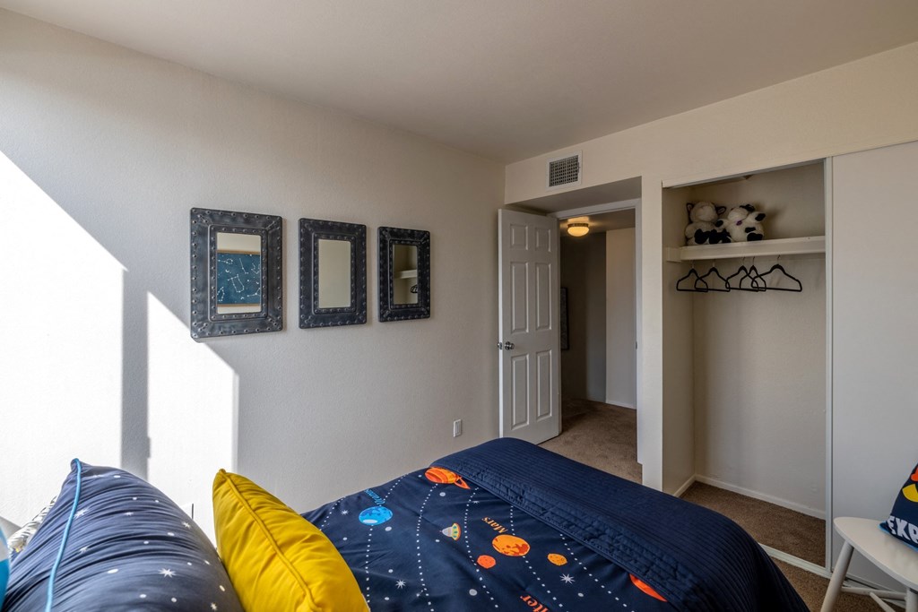 a bedroom with a bed and a hallway with a door to a closet