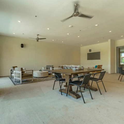 A modern dining room with a wooden table and chairs.