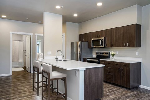 A kitchen with brown cabinets and white countertops.