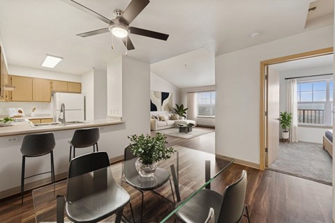 A modern kitchen with a dining table and chairs.