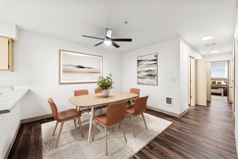 A dining room with a table and chairs.