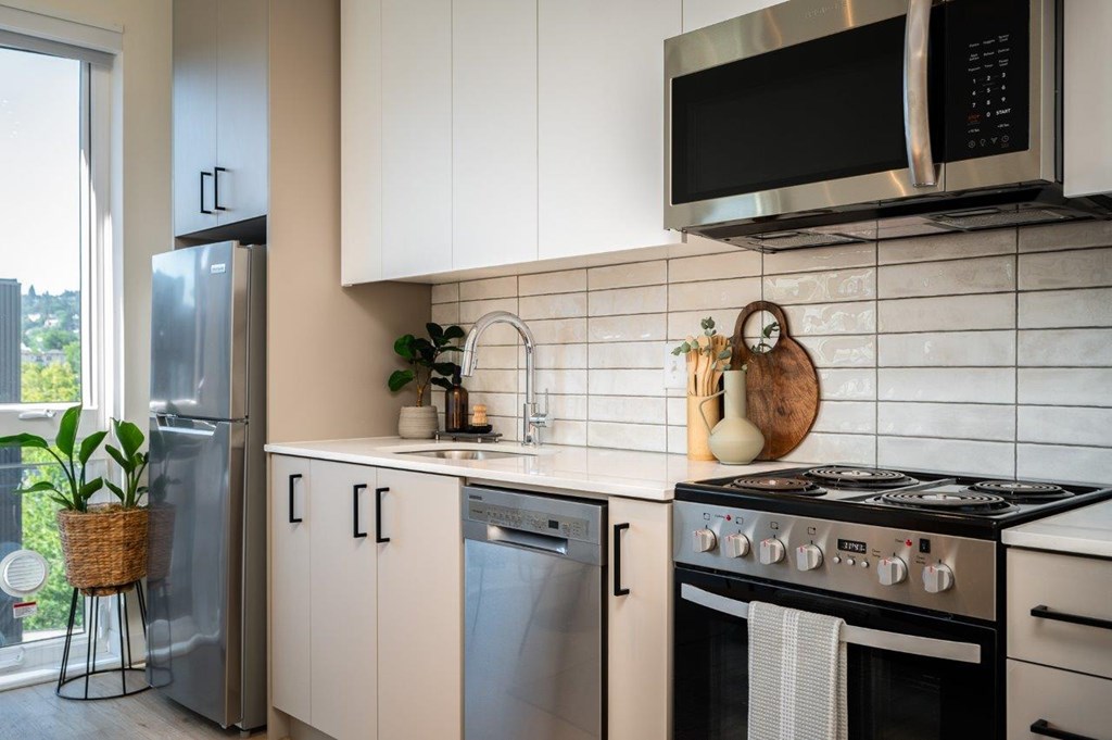 MERX Slabtown modern kitchen with a black microwave above the stove.