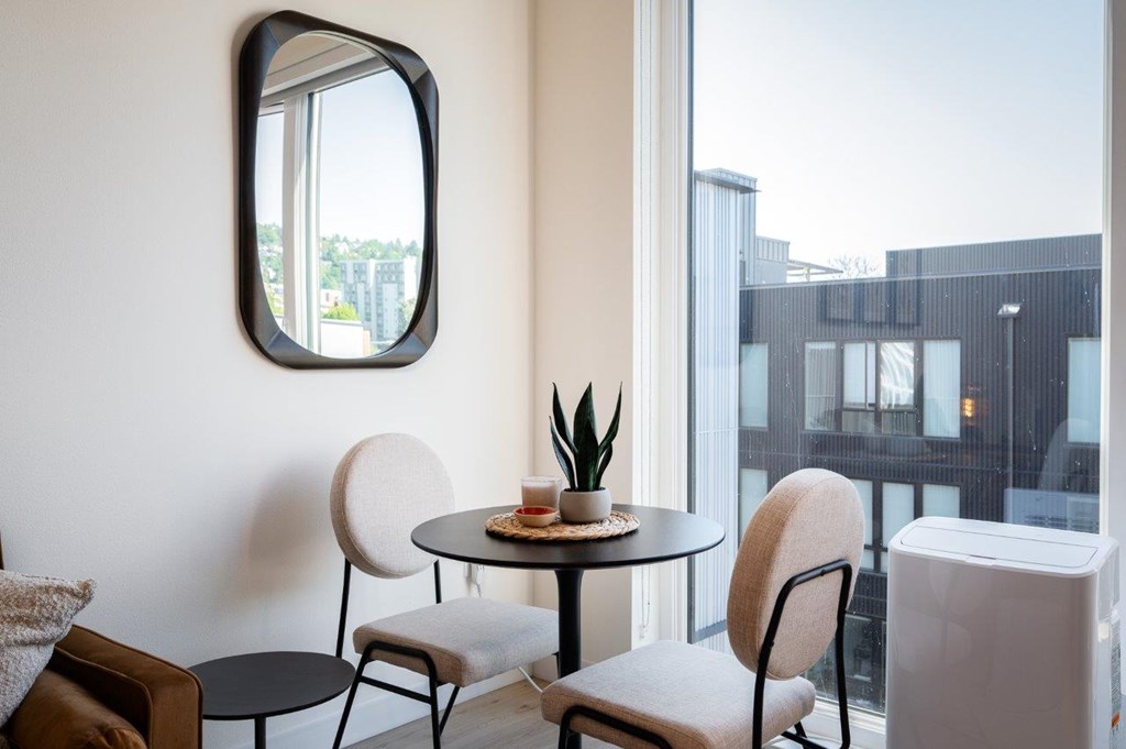 MERX Slabtown round table with a plant on it sits in front of a large window overlooking Northwest Portland Oregon.