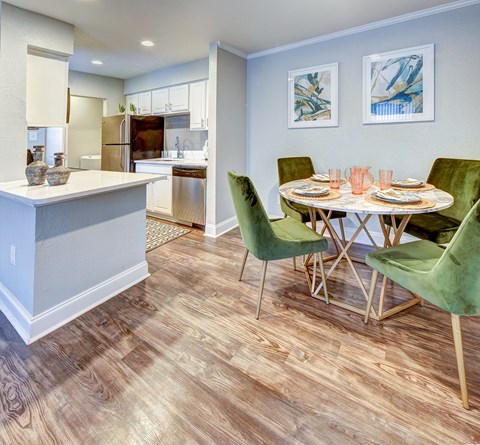 a dining room and kitchen with a table and chairs
