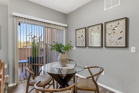 A dining room with a glass table and chairs.
