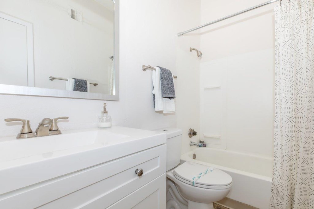 A white bathroom with a toilet and a sink.