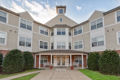 A large apartment complex with a central courtyard and covered entrance.