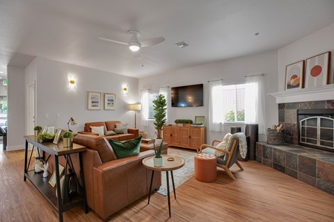 A living room with a brown leather couch and a wooden coffee table.