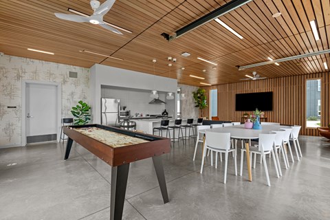 a game room with a pool table and a dining table