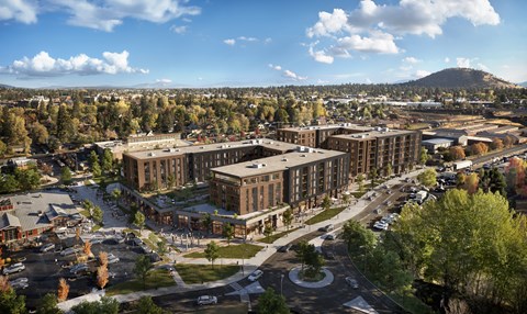 A large building complex with a parking lot in front.