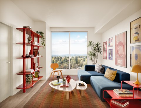 A living room with a red bookshelf and a blue couch.