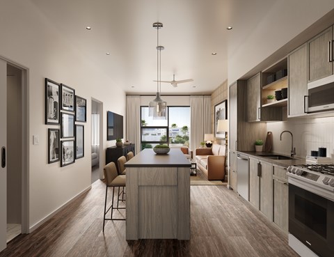 A modern kitchen with a large island and a dining area.