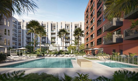 A modern apartment complex with a pool in the foreground.