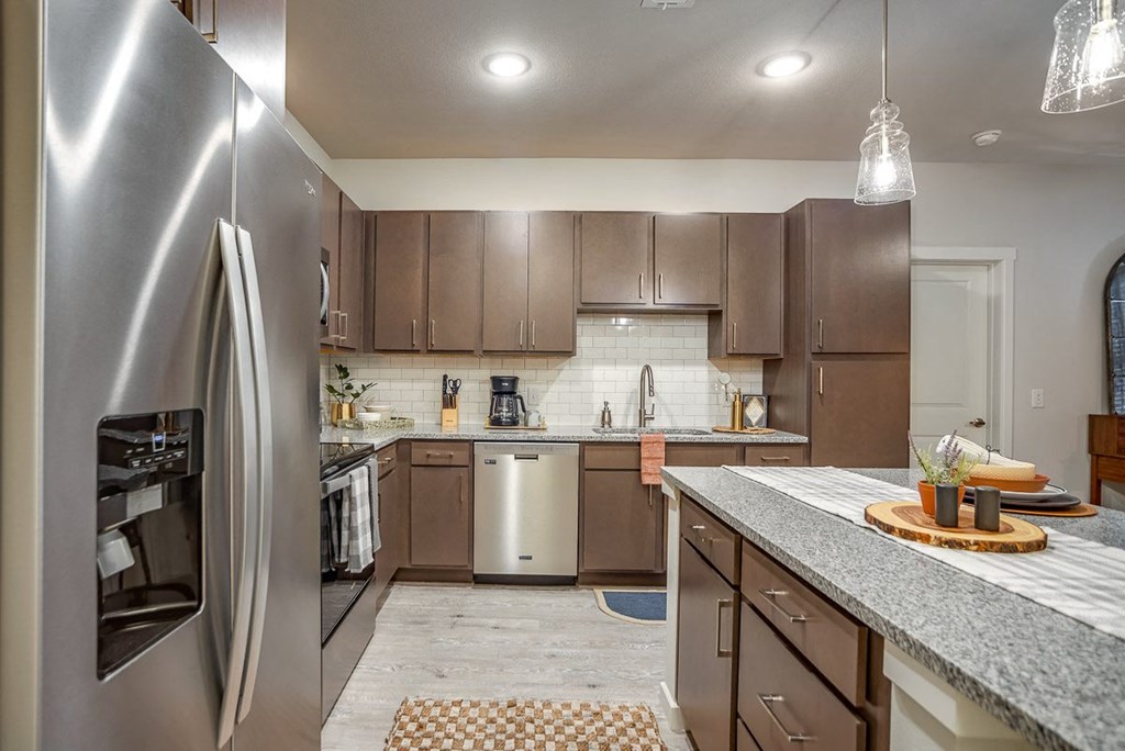 a kitchen with stainless steel appliances and granite counter tops