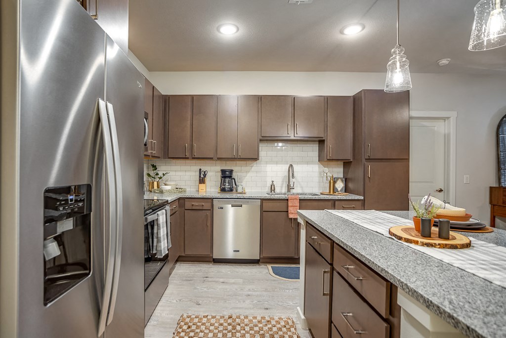 Discovery at the Realm Apartments kitchen with stainless steel appliances and large kitchen island