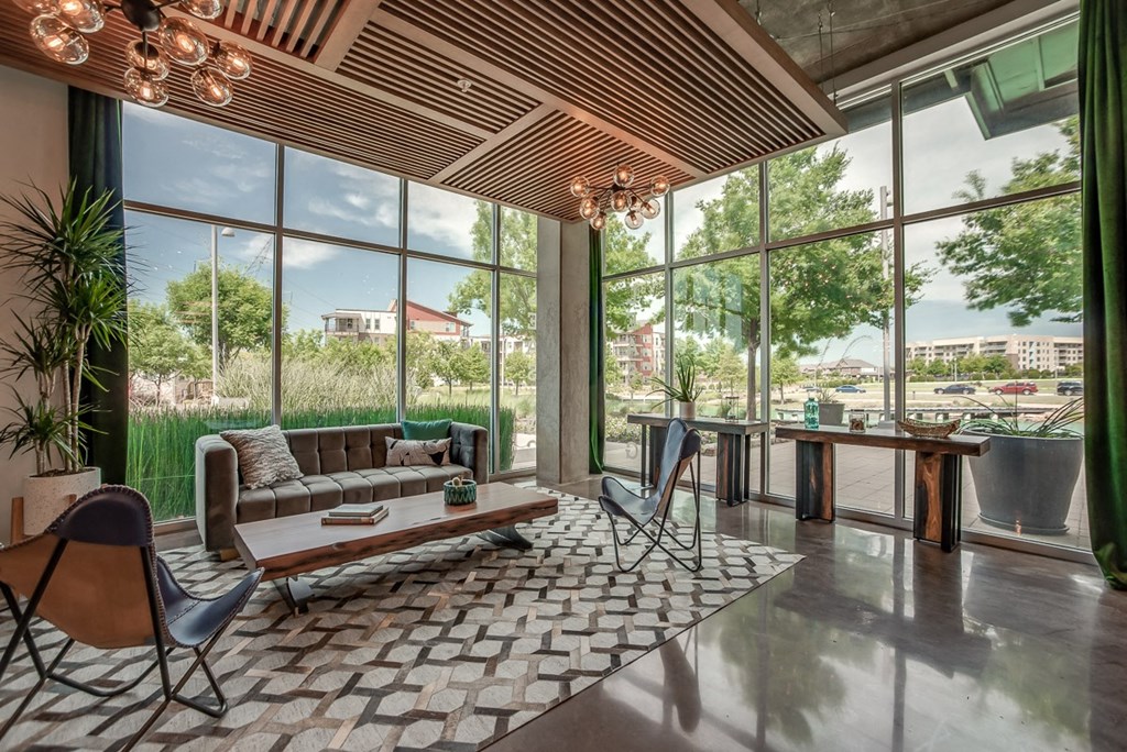 a living room with large windows and a couch and a table