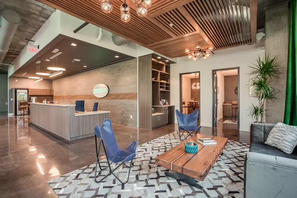 a lobby with a table and chairs and a reception desk