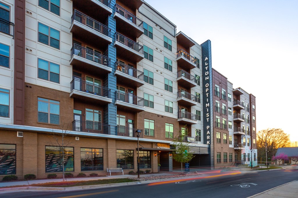 picture of an apartment building with a street in front of it