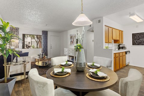 a dining room and kitchen with a table and chairs