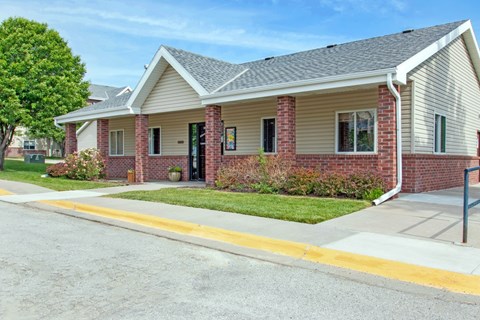 A house with a red brick wall and a grey roof.