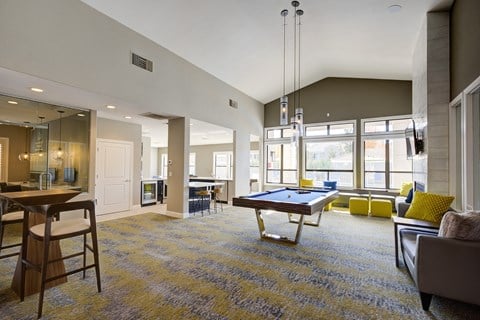an open living room with a pool table in the center