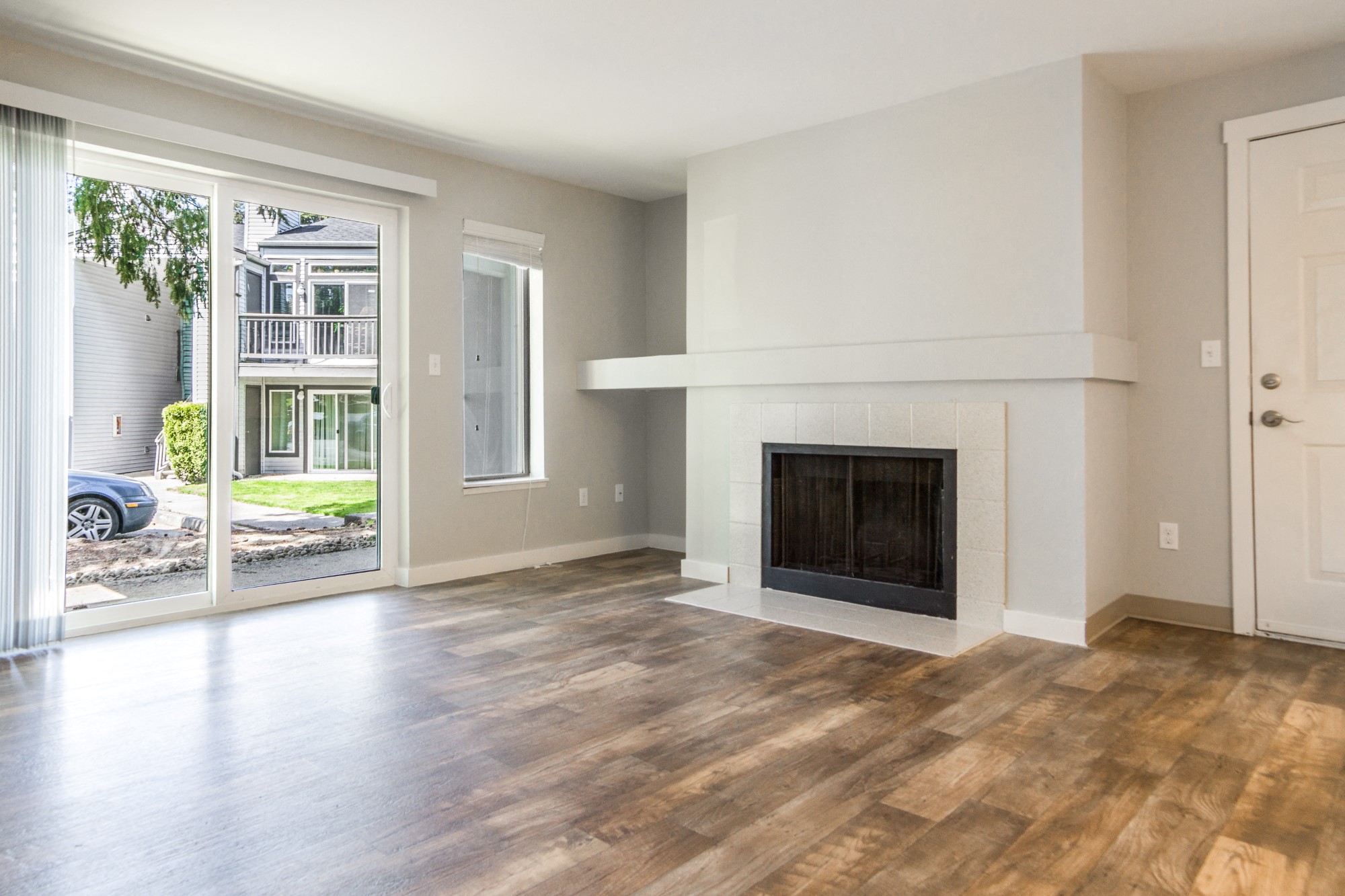 Novela Apartment Homes Living Room Fireplace and Patio Door