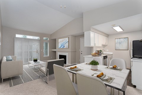 a living room with a dining room table and chairs and a fireplace in the background