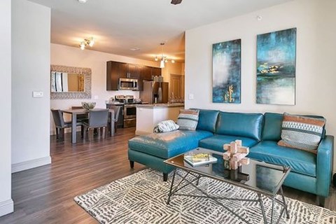 A living room with a blue couch and a coffee table.