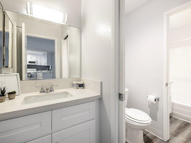 A white bathroom with a toilet and sink.