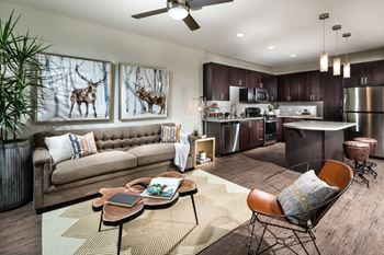 A modern living room with a brown leather couch and a coffee table with a book on it.