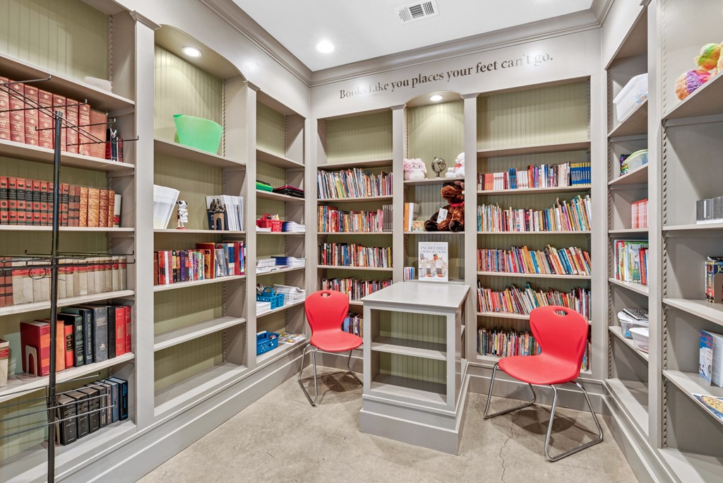A room with bookshelves and a sign that says "like you places your feet can't".