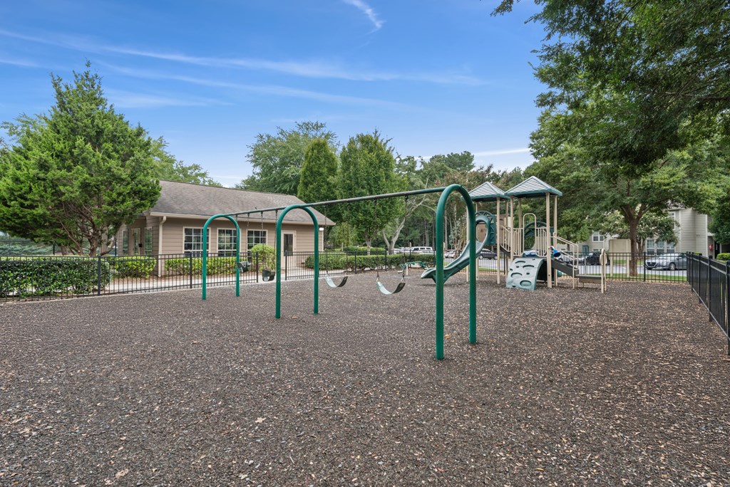A playground with a swing set and a slide.