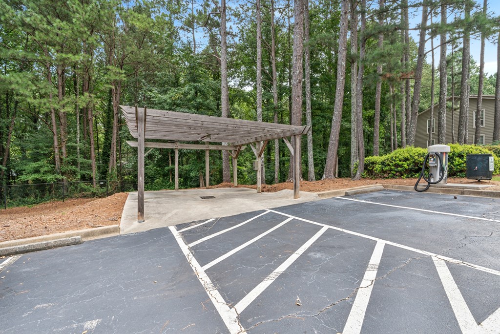 A parking lot with a wooden structure in the middle.