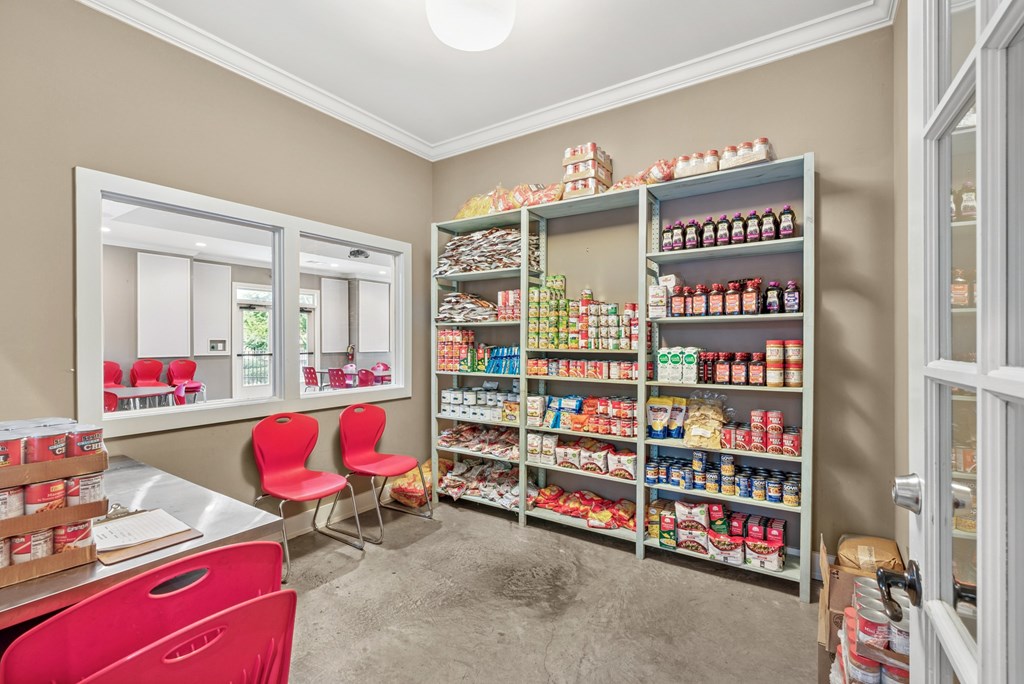 A room with a pantry and a dining table.